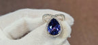 18k White + Yellow Gold with a Ceylon Purple Blue Sapphire Sounded in a Unique Diamond Swirl.