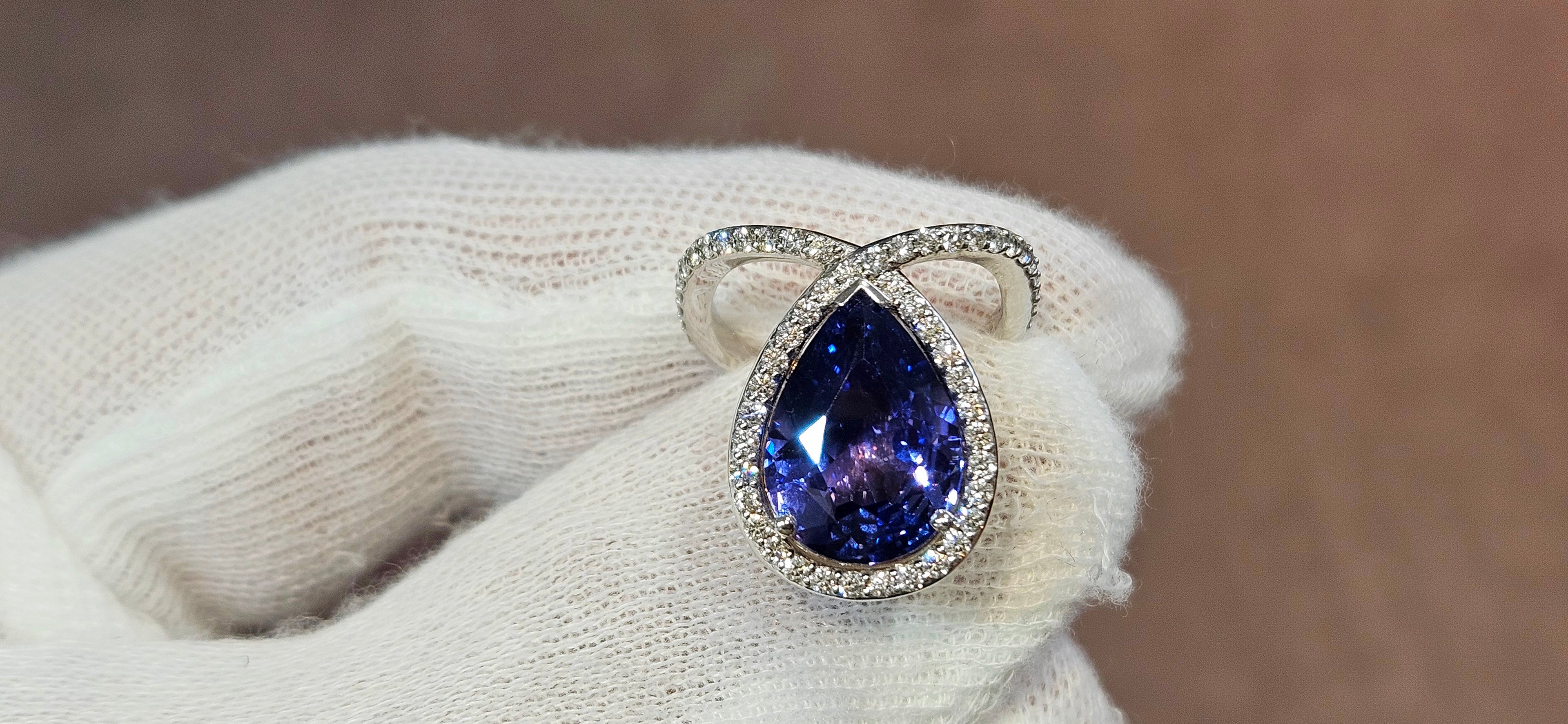 18k White + Yellow Gold with a Ceylon Purple Blue Sapphire Sounded in a Unique Diamond Swirl.
