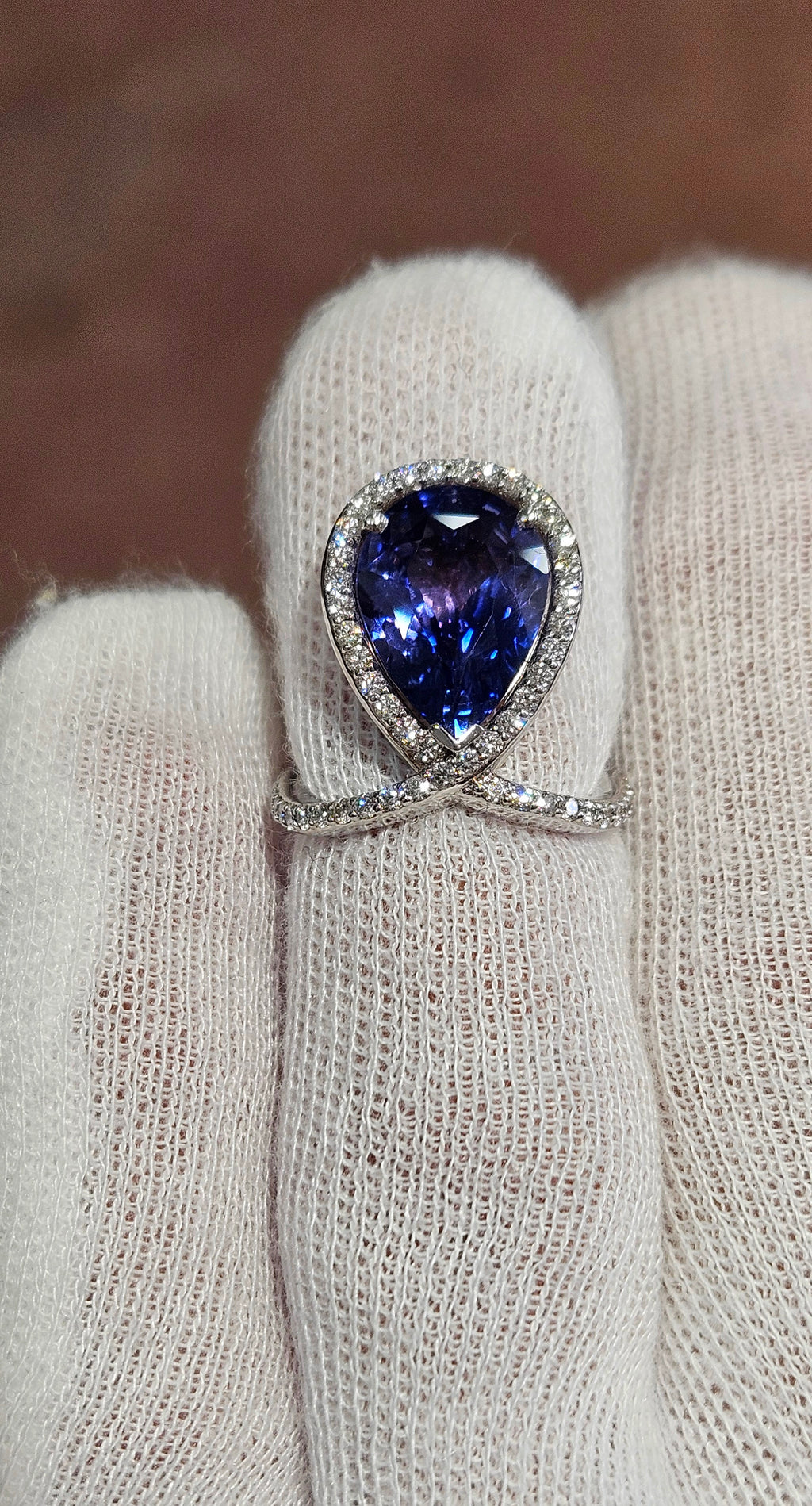 18k White + Yellow Gold with a Ceylon Purple Blue Sapphire Sounded in a Unique Diamond Swirl.