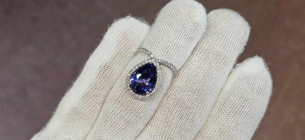 18k White + Yellow Gold with a Ceylon Purple Blue Sapphire Sounded in a Unique Diamond Swirl.