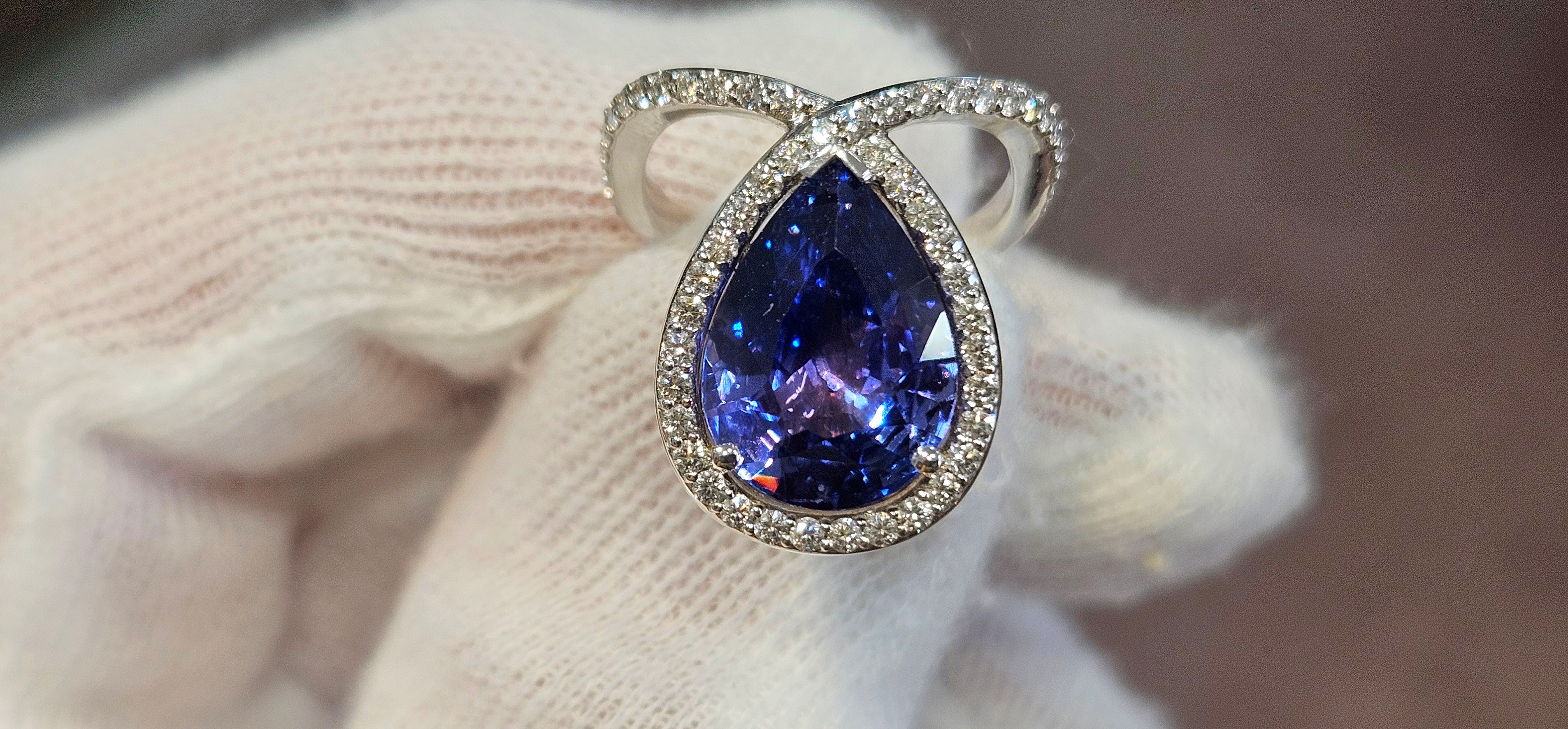 18k White + Yellow Gold with a Ceylon Purple Blue Sapphire Sounded in a Unique Diamond Swirl.