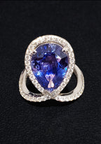 18k White + Yellow Gold with a Ceylon Purple Blue Sapphire Sounded in a Unique Diamond Swirl.