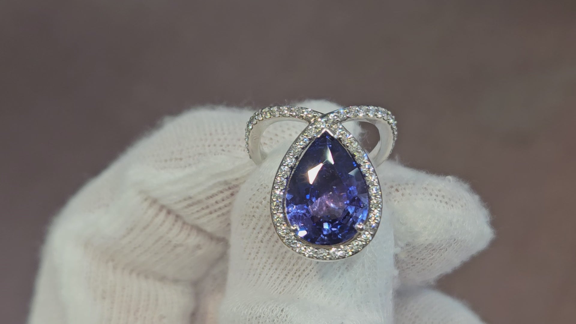 18k White + Yellow Gold with a Ceylon Purple Blue Sapphire Sounded in a Unique Diamond Swirl.
