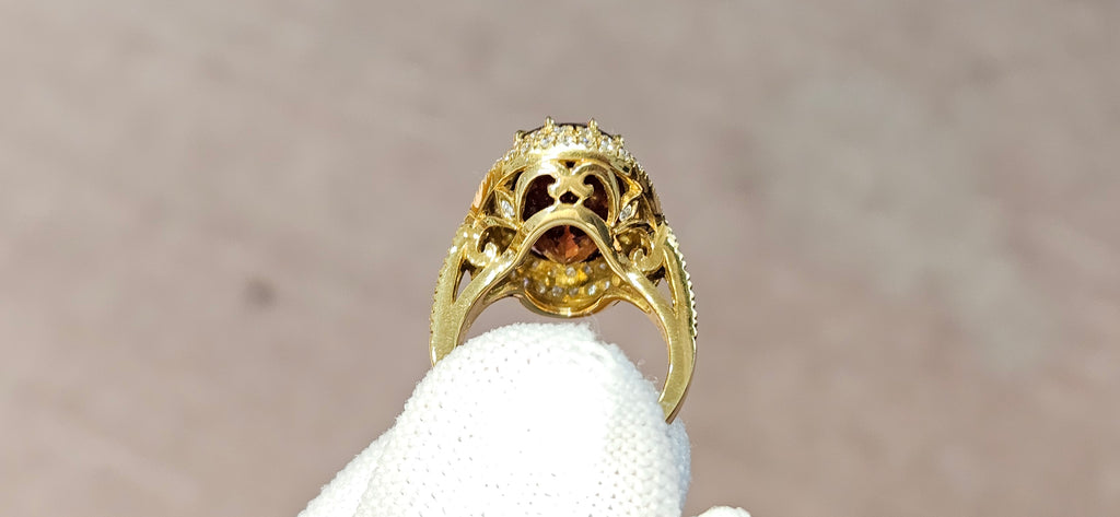 Fine, large Madagascar Spessartite in hand carved 18ky gold with .83cts of diamonds
